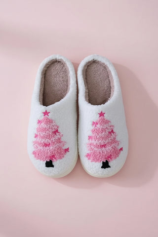 White slippers with pink Christmas tree design on a white background
